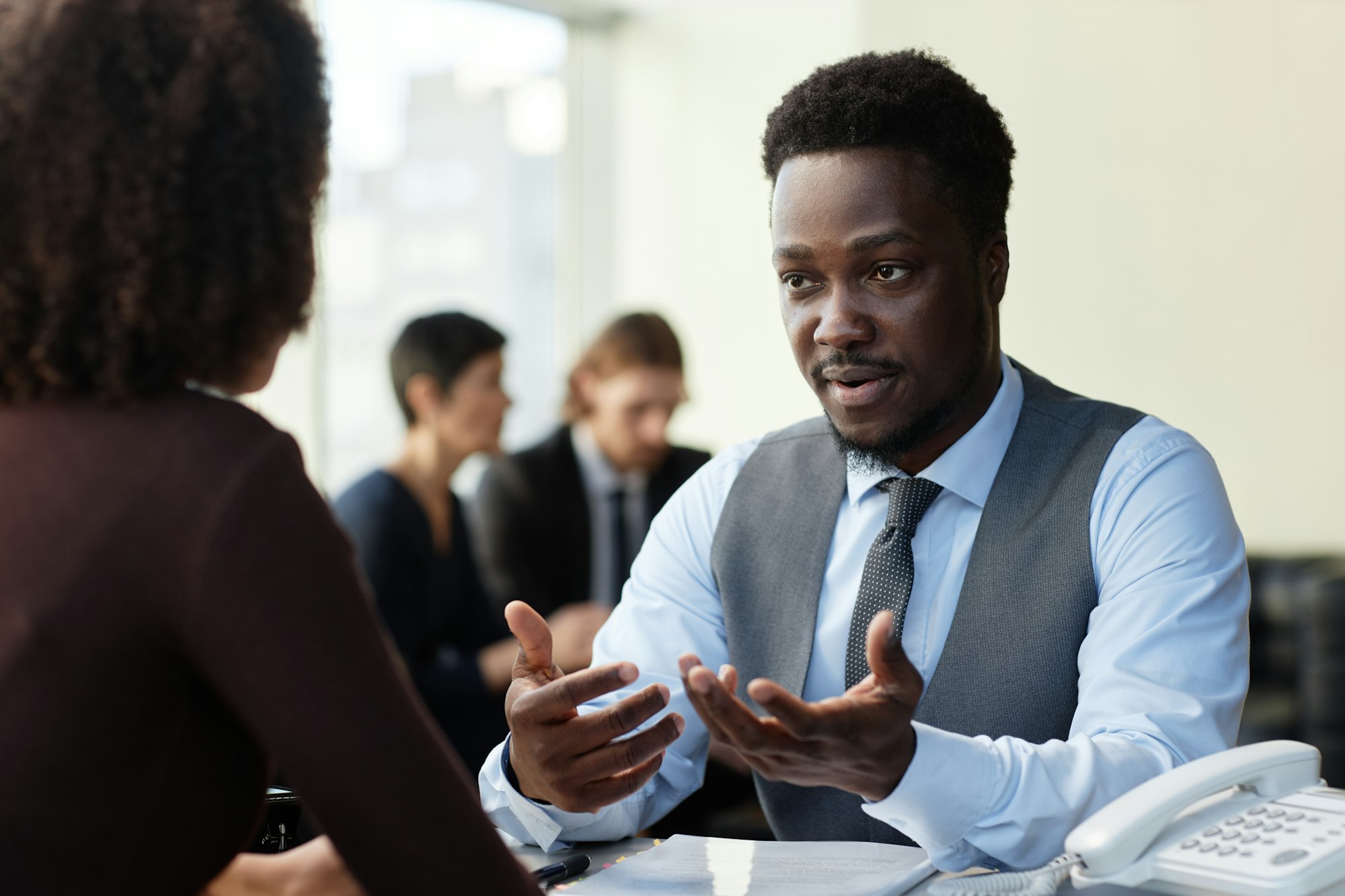 Professional black businessman consulting client at legal firm