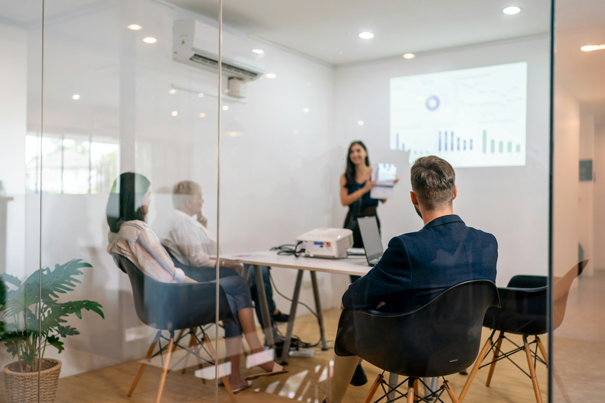 Shot of a mature businesswoman sitting and training her team in the office.